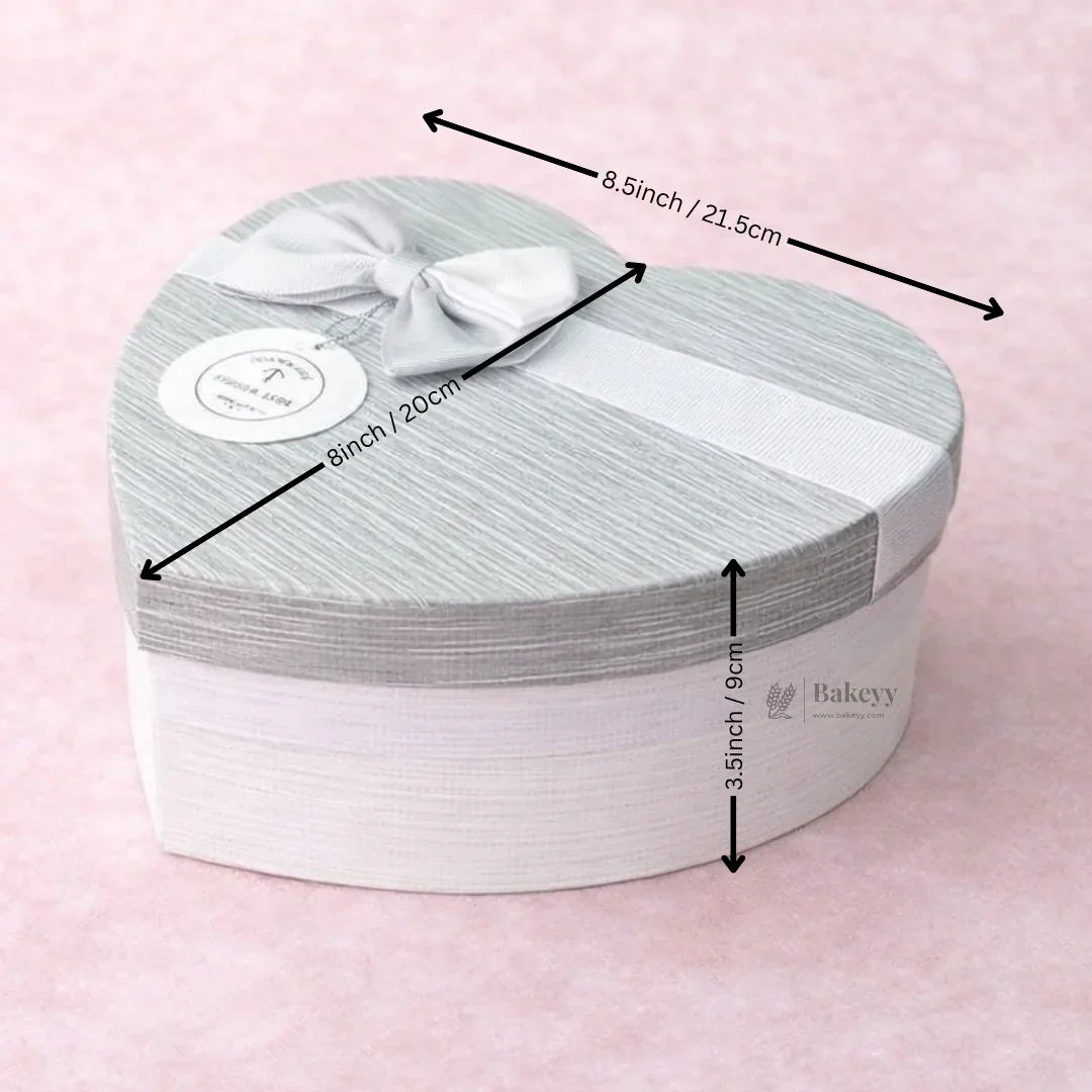 Grey and white heart-shaped gift box with bow, Bakeyy hamper packaging, size labeled