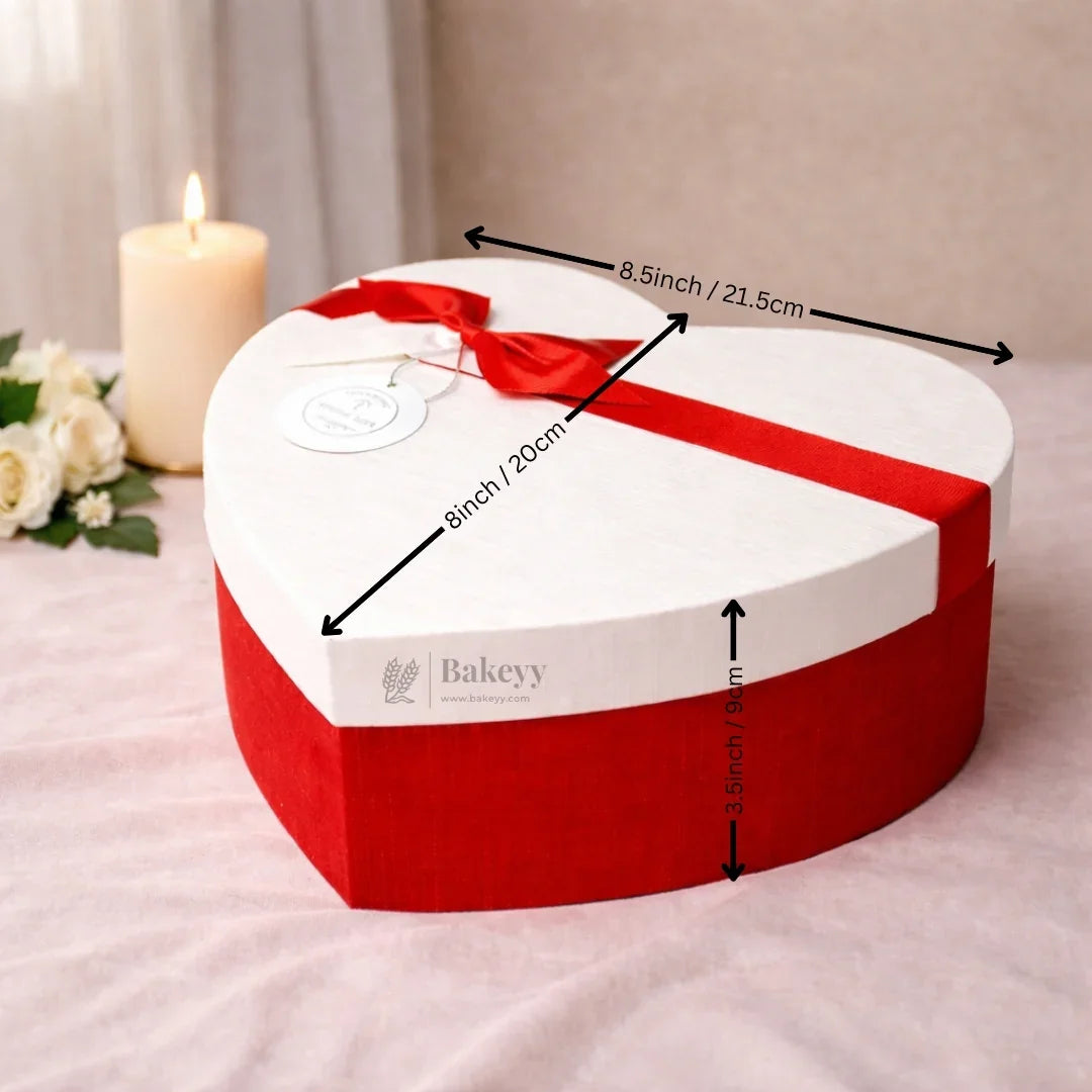 Heart-shaped red and white gift box with ribbon and measurements, Bakeyy bakery packaging.
