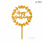 Yellow 'Happy Birthday' cake topper with leaf design on a white background, featuring Bakeyy branding.