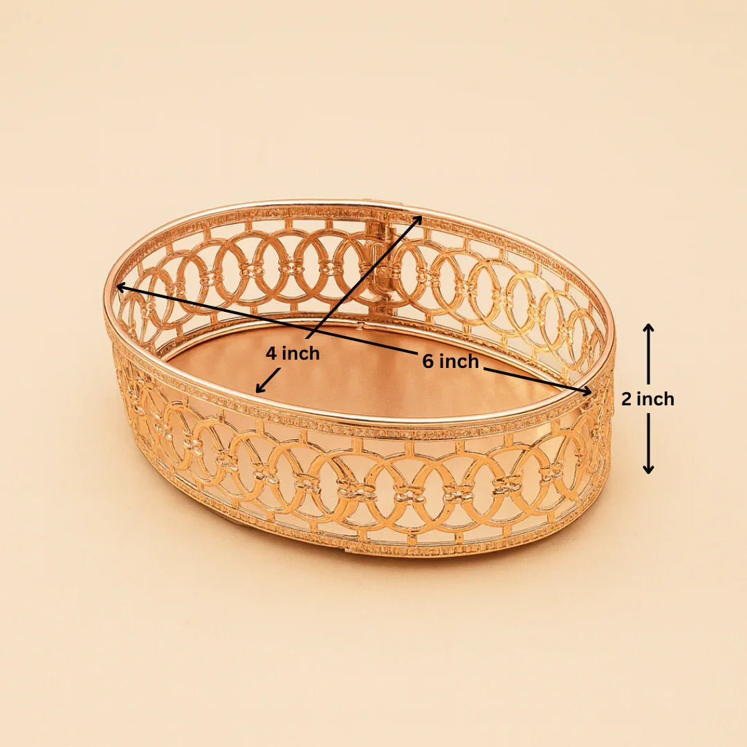 Decorative gold bowl with dimensions labeled on a beige background