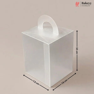 Clear plastic gift box with dimensions and handle on a beige background, featuring the brand 'Bakeyy'.