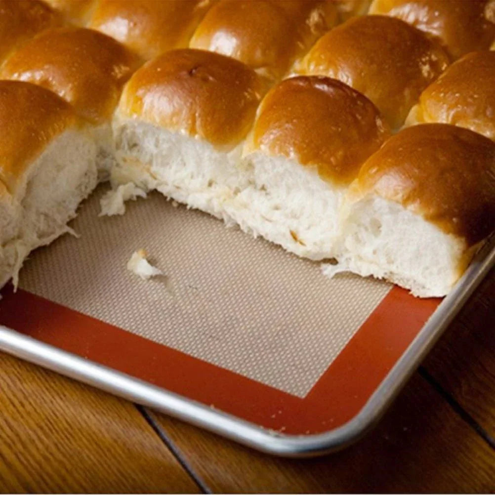 Freshly baked bread rolls on a non-stick silicone baking mat, perfect for bakery supplies