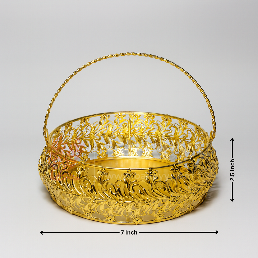Gold decorative basket with intricate patterns on a light gray background