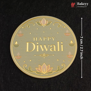 A round Diwali-themed decorative plaque or coaster with 'HAPPY Diwali' text, lotus flowers, and small diya illustrations on a black background. White measurement text at the right indicates 7 cm / 2.