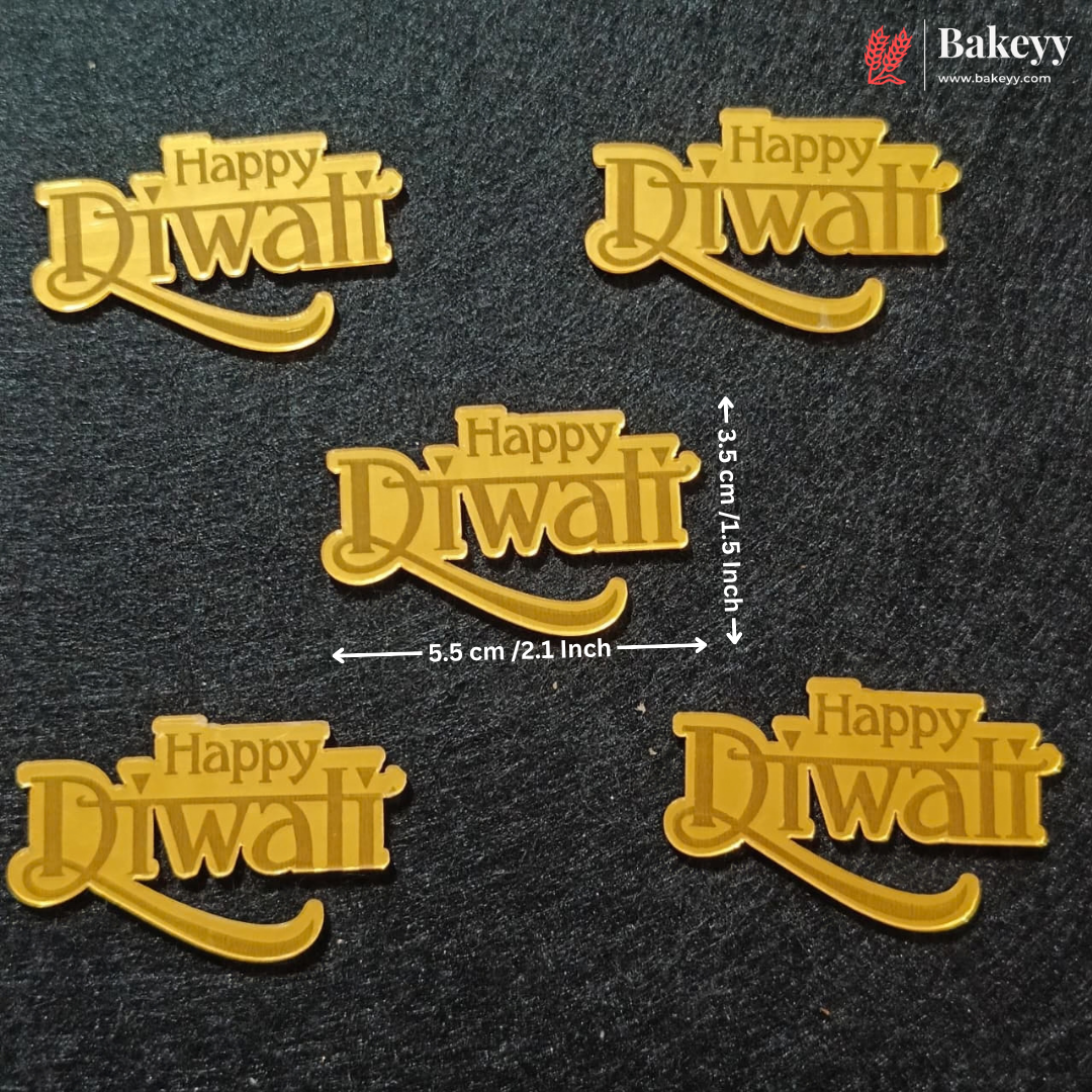 Five gold-colored 'Happy Diwali' text decorations arranged on a dark textured background, with dimension arrows and labels showing 5.5 cm by 3.