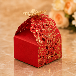 Decorative red gift box with floral patterns on a marble surface