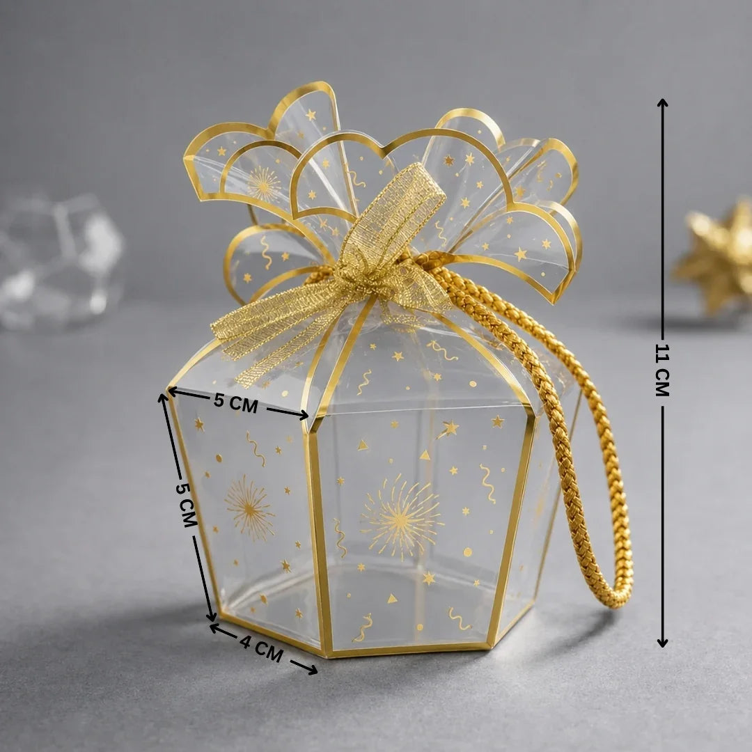 Clear gift box with gold bow and decorative elements on a gray background