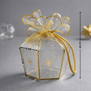 Clear gift box with gold bow and decorative elements on a gray background