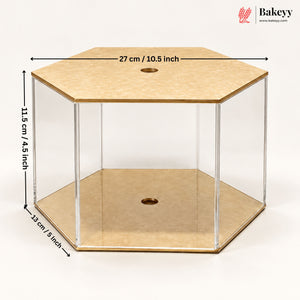 Hexagonal acrylic and wood display case with dimension labels showing 27 cm top, 11.5 cm height, and 12 cm base, on a white background.