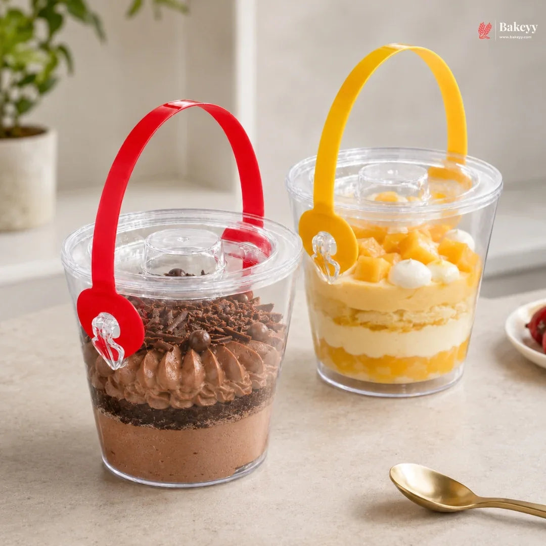 Two dessert cups with colorful handles on a light surface, featuring the Bakey brand.