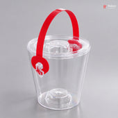 Clear plastic ice bucket with a red handle on a gray background