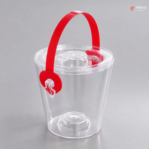Clear plastic ice bucket with a red handle on a gray background