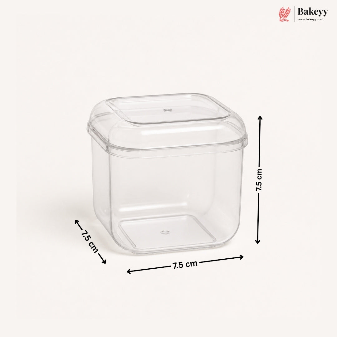A clear plastic square container with a matching lid, shown on a light beige background with black dimension arrows and labels indicating 7.5 cm on each side.