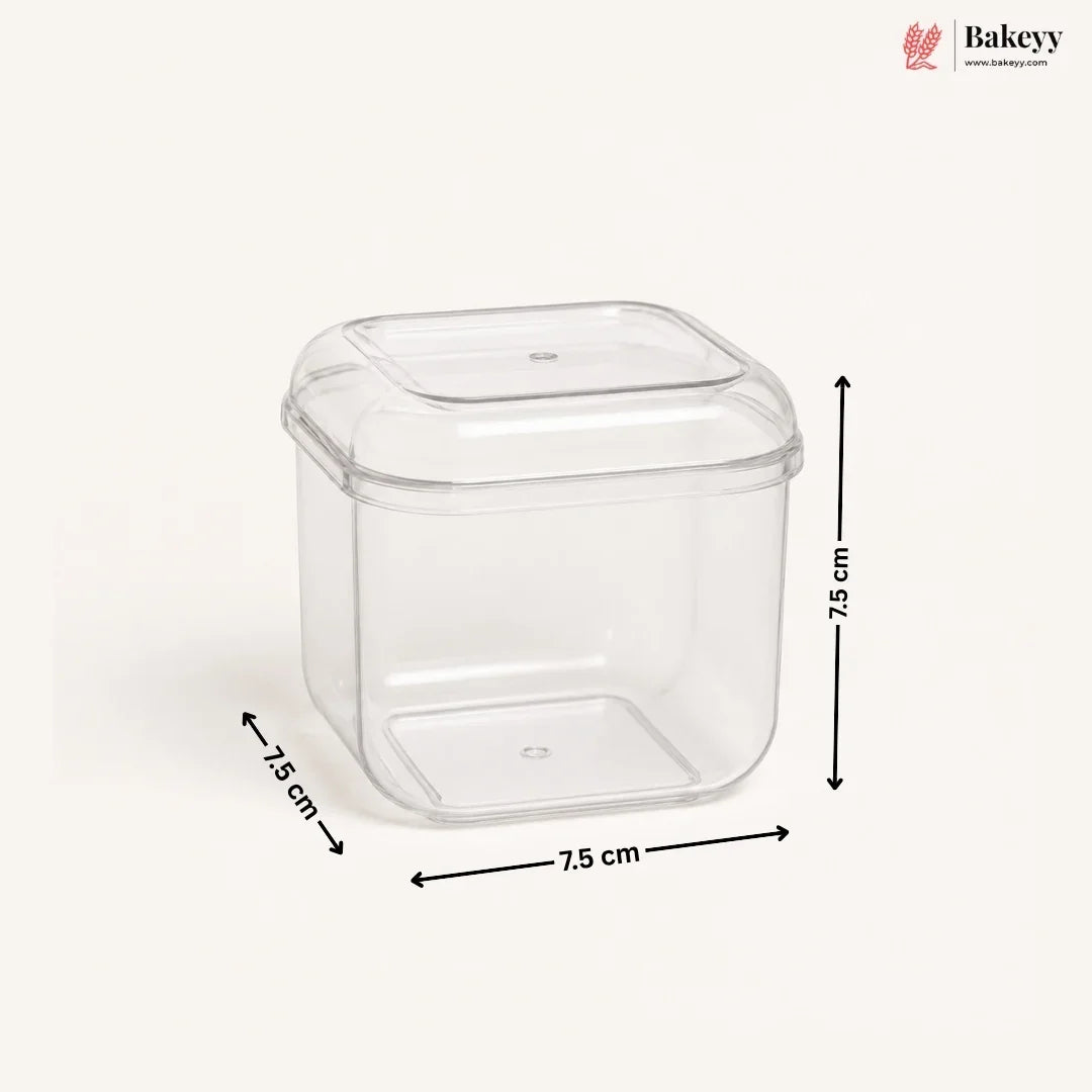 A clear plastic square container with a matching lid, shown on a light beige background with black dimension arrows and labels indicating 7.5 cm on each side.