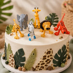 Cake with animal figurines and leaf decorations on a neutral background