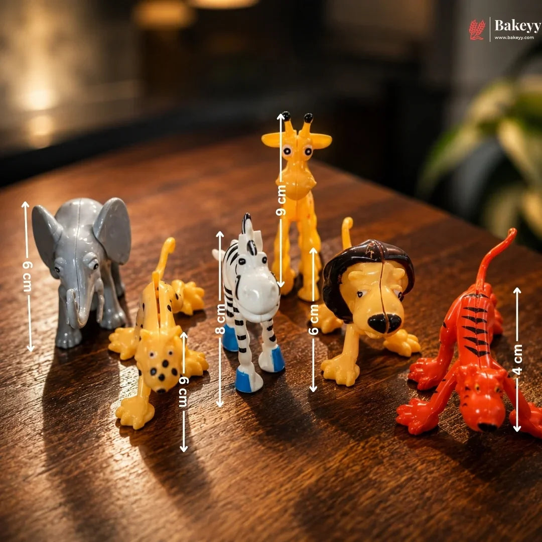 Set of small animal figurines with measurements on a wooden surface, featuring Bakey brand.