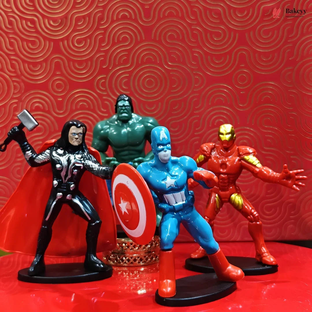 Four superhero action figures on a red surface with a red patterned background