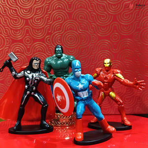 Four superhero action figures on a red surface with a red patterned background