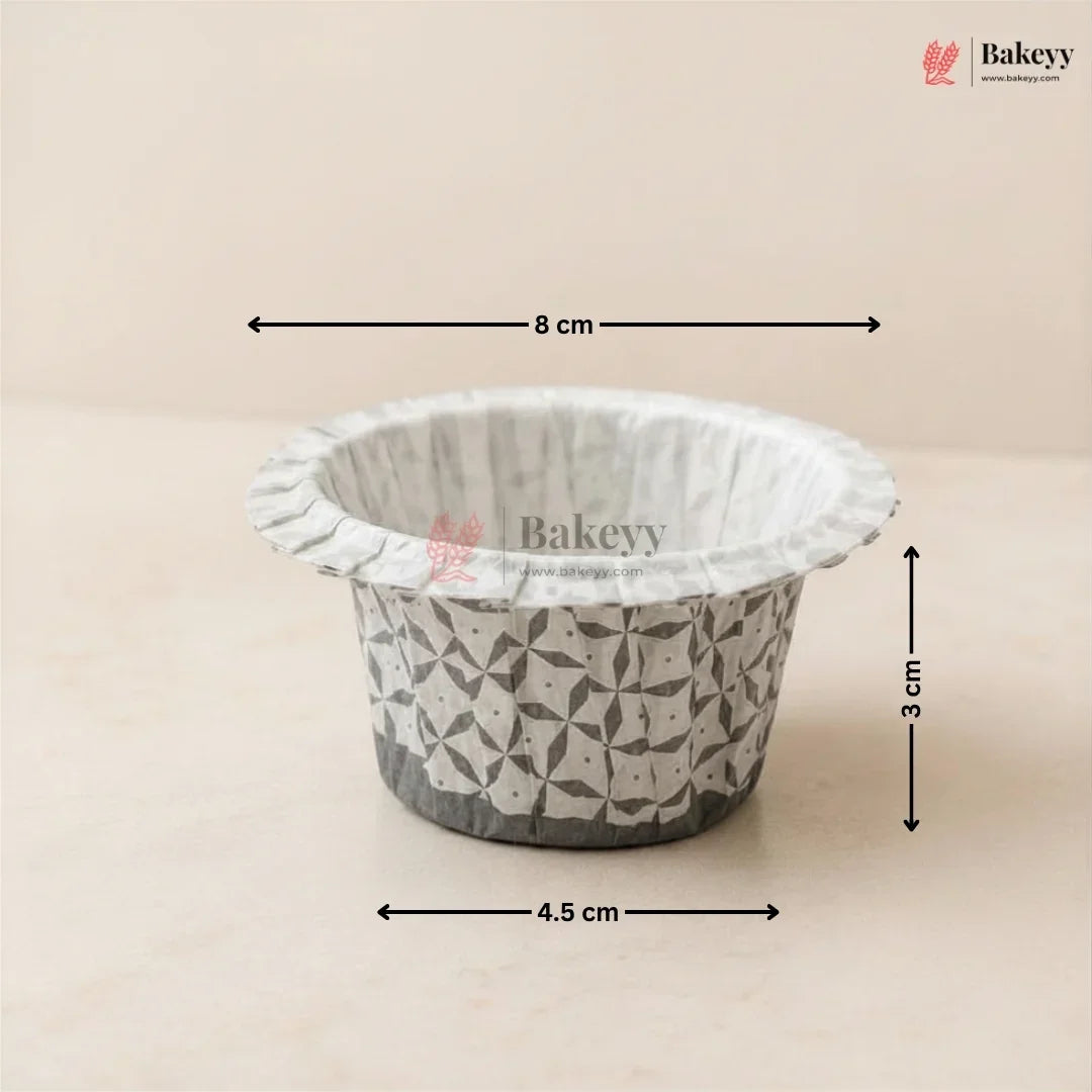 Bakey disposable cup with geometric pattern and measurements on a beige background