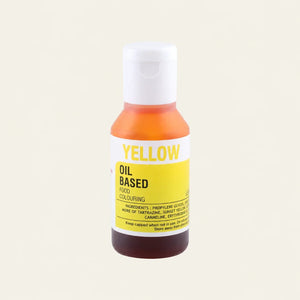 A bottle of Yellow Oil Based Food Colouring with a white cap, featuring a white and yellow label, set against a solid off-white background.