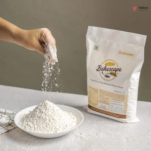 Bakescape brand wheat flour being poured from a package into a bowl on a neutral background