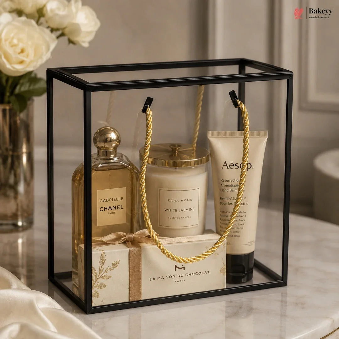 Gift set with Chanel perfume, candle, and Aesop hand cream in a decorative box.
