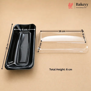 Black rectangular bakery tray with dimension arrows and measurements next to a clear plastic lid, on a beige background. The Bakeyy logo is in the top right corner.
