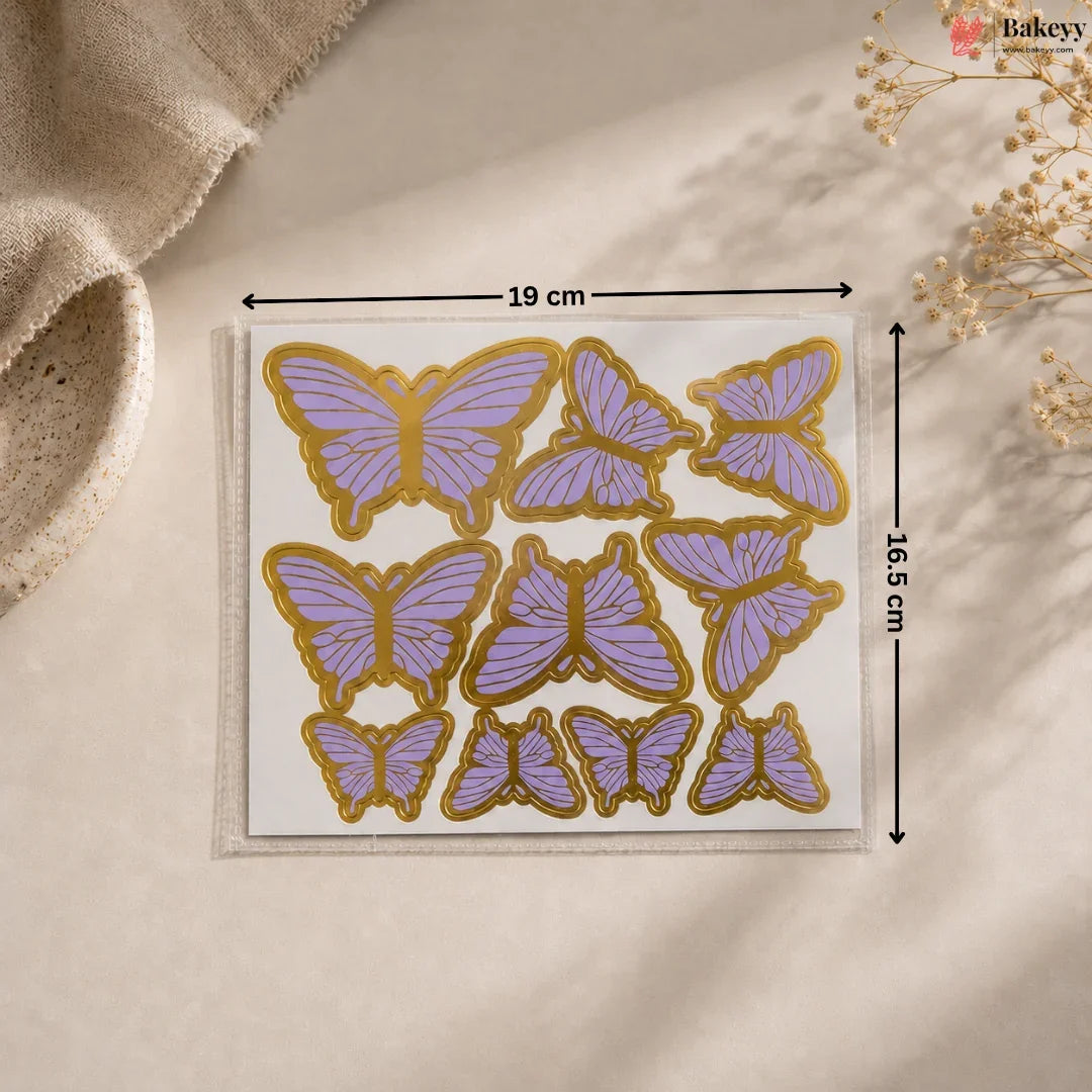 Butterfly-shaped stickers with gold and purple design on a beige background
