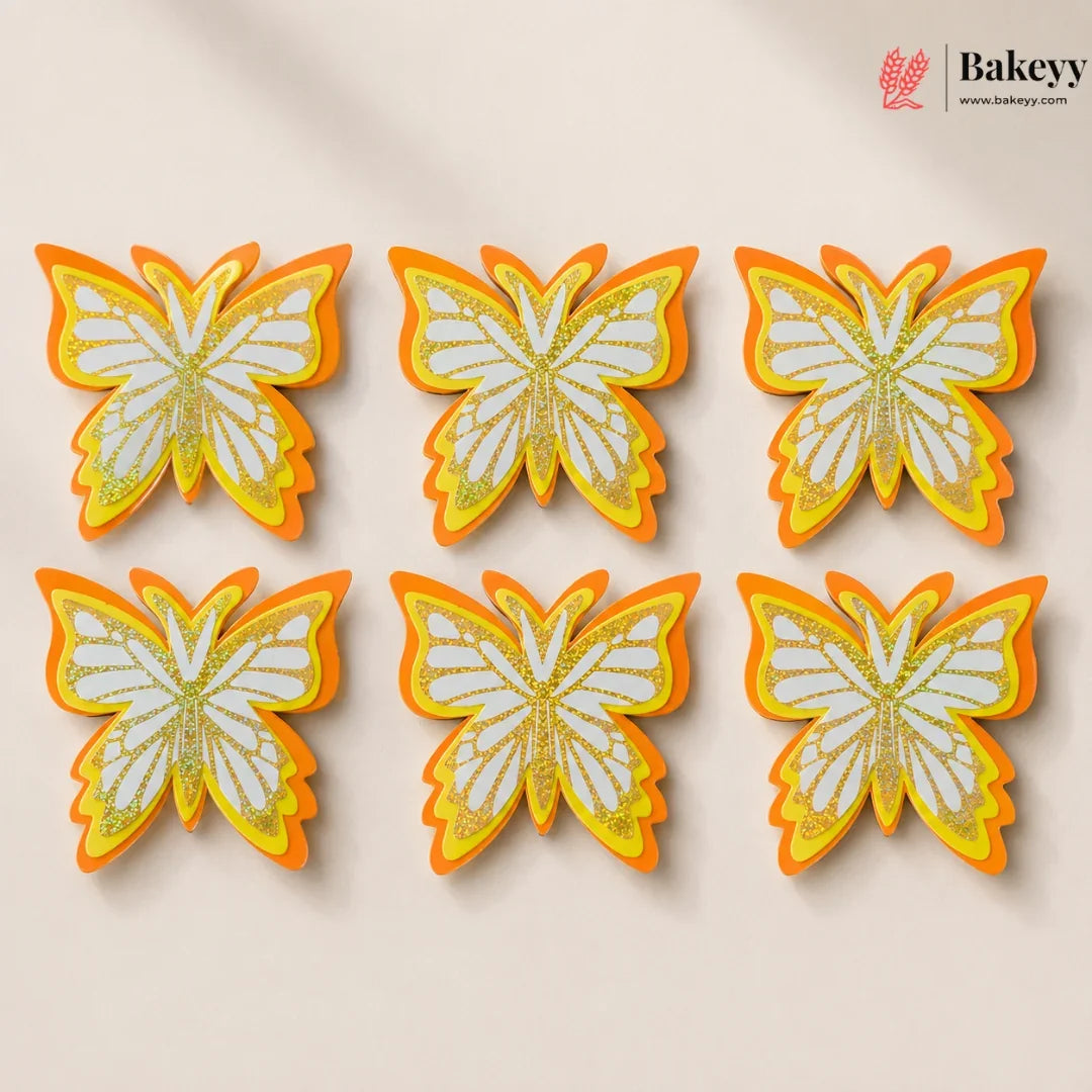Butterfly-shaped cookies with orange and yellow accents on a beige background, branded 'Bakeyy'.