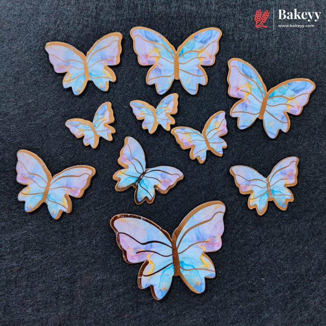 A set of iridescent butterfly-shaped baking cookies or sugar cookies arranged on a dark textured background, with a Bakeey brand logo in the top right corner.
