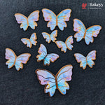 A set of iridescent butterfly-shaped baking cookies or sugar cookies arranged on a dark textured background, with a Bakeey brand logo in the top right corner.