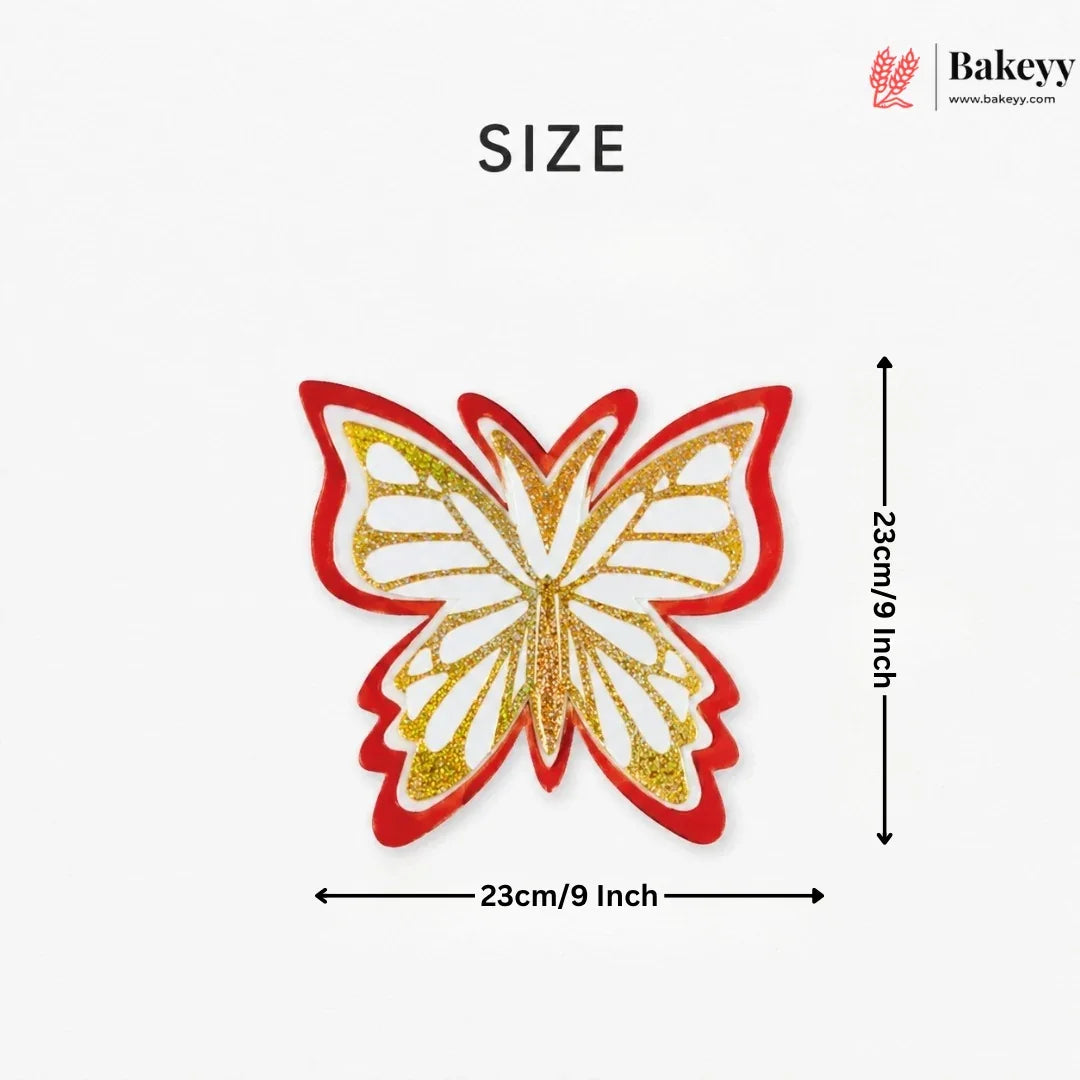 Butterfly-shaped patch with red and gold glittery design, size indicated as 23cm/9 inch, on a white background with Bakeyy branding.