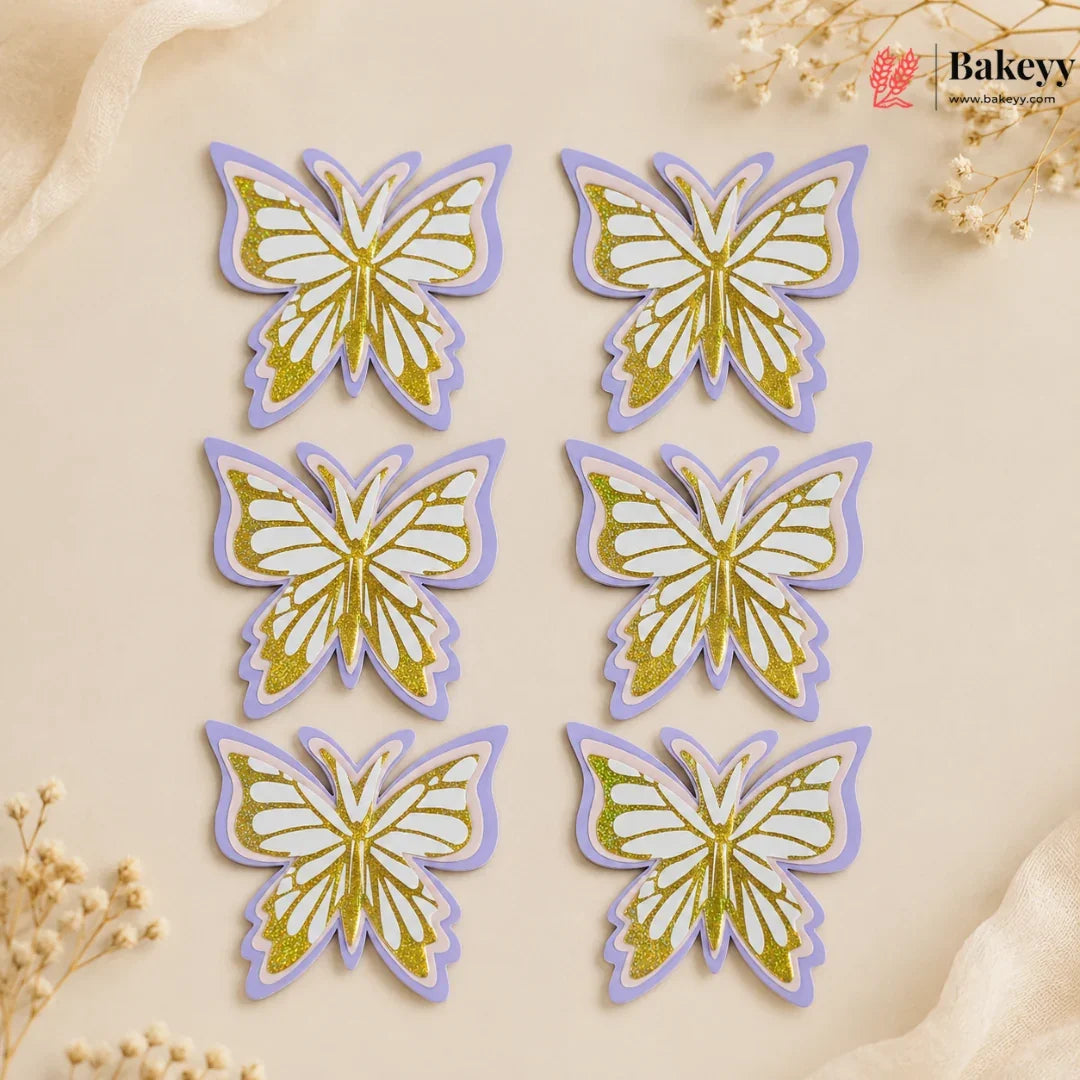 Six butterfly-shaped decorations with gold and purple details on a beige background, branded 'Bakeyy'.