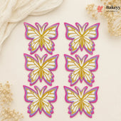Set of butterfly-shaped decorations with gold and pink outlines on a beige background, featuring the brand 'Bakeyy'.
