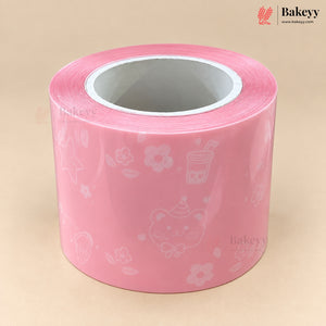 A roll of pink decorative tape with white line-art illustrations of a cat, flowers, and a boba cup, shown on a beige background with the Bakeyy brand logo in the top right.