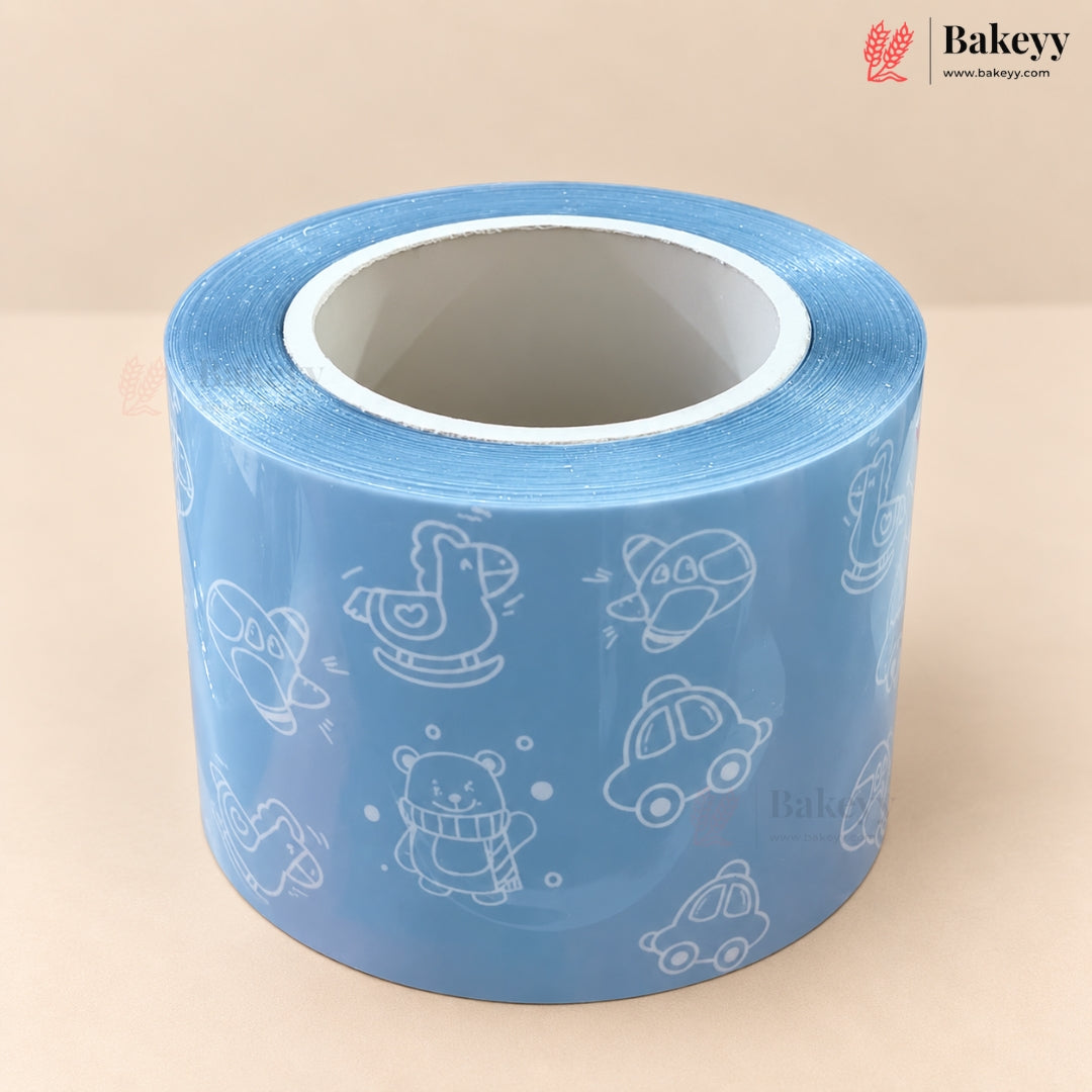 A roll of light blue tape with white line-art illustrations of cartoon bakers, cars, and a rocking horse, shown on a neutral beige background with the Bakeyy brand logo in the top right.