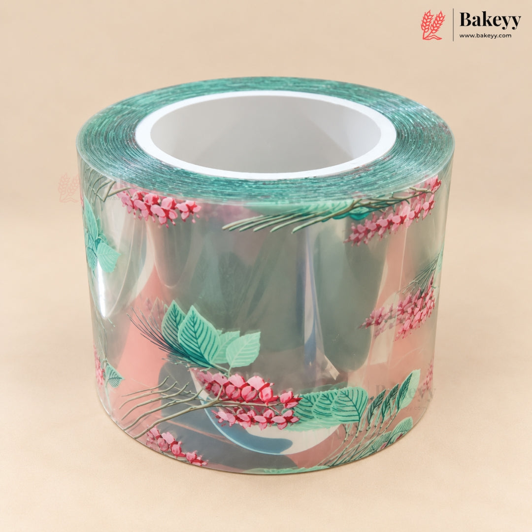 A roll of clear adhesive tape with a botanical pattern of pink berries and green leaves, displayed on a solid beige background. The Bakeyy logo is visible in the top right corner.