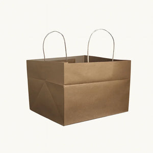 Brown kraft paper cake bag with handles, ideal for bakery gift packaging from Bakeyy.com