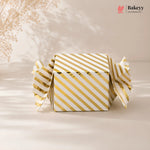 Gold and white striped box with 'Bakeyy' branding on a beige background