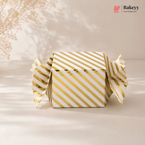 Gold and white striped box with 'Bakeyy' branding on a beige background
