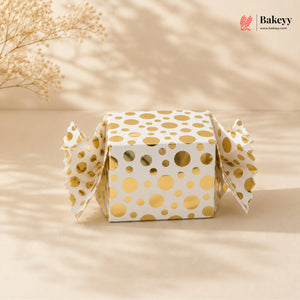 Gift box with gold polka dots on a beige background, featuring the Bakeyy brand.