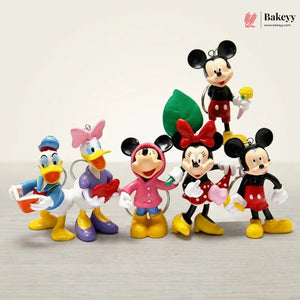 Set of cartoon character figurines including Mickey and Minnie Mouse, Donald Duck, and Daisy Duck on a light background.