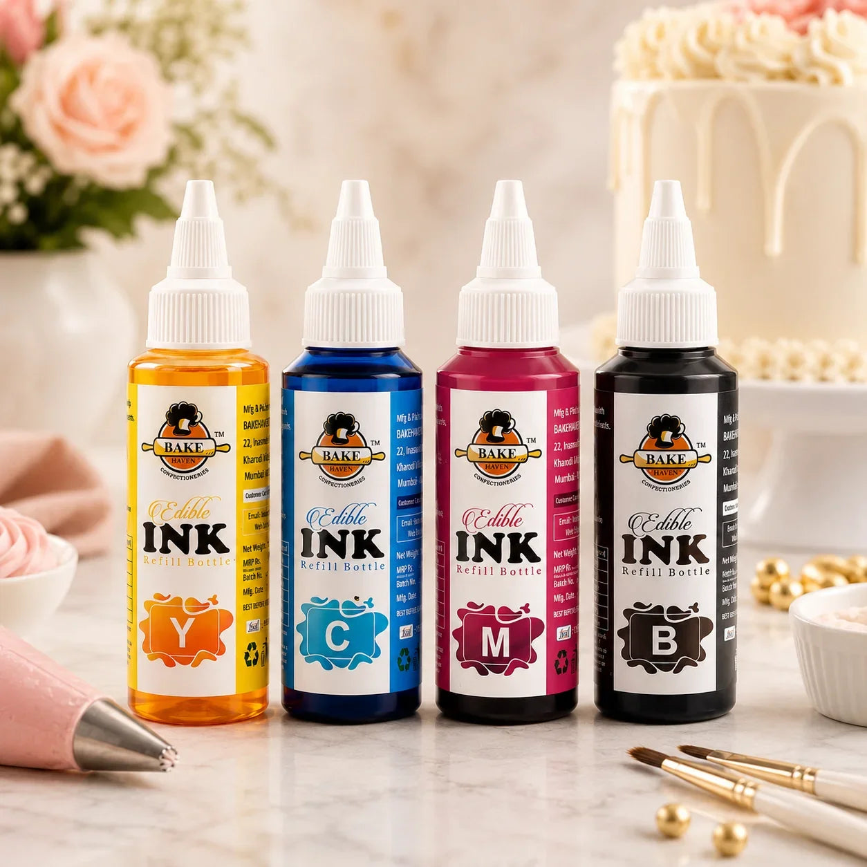 Four bottles of Bake Sale Edible Ink with a cake and flowers in the background