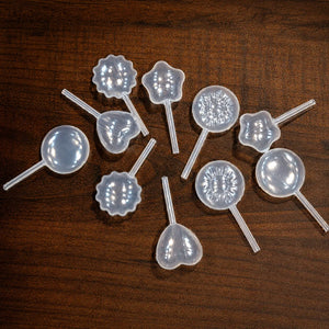 Silicone lollipop molds on a wooden surface