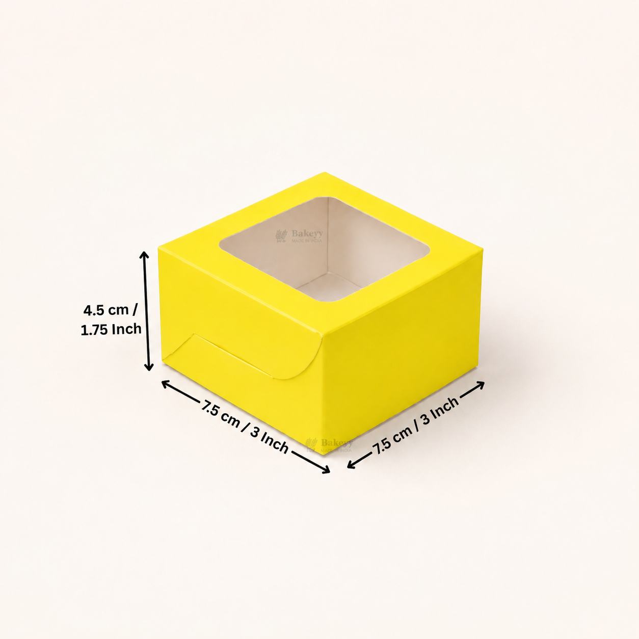 A bright yellow square paper box with a clear window on top, shown on a light beige background with black dimension arrows and text indicating 7.5 cm / 3 inch by 7.