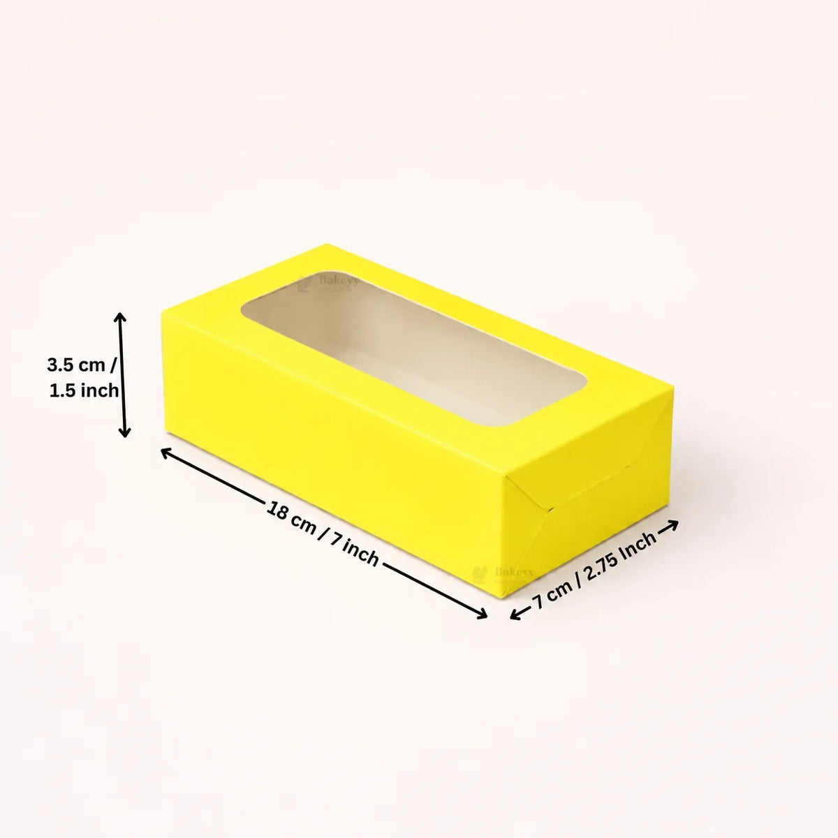 A bright yellow rectangular display box with a clear window on top, shown on a light beige background with dimension arrows and labels indicating 18 cm length, 7 cm width, and 3.5 cm height.