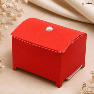 Red jewelry box with a pearl on a beige background