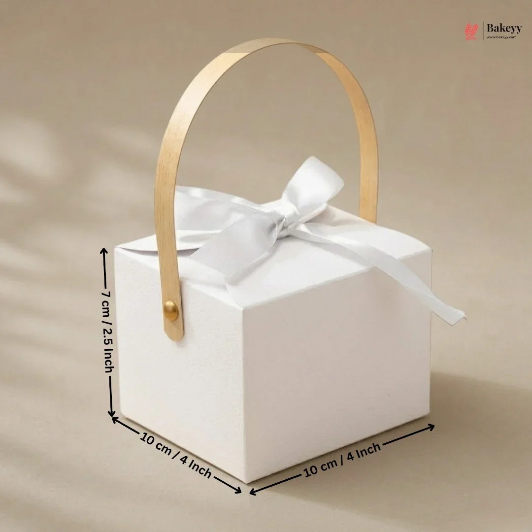 White gift box with gold handle and white ribbon, shown with measurements on a beige background.