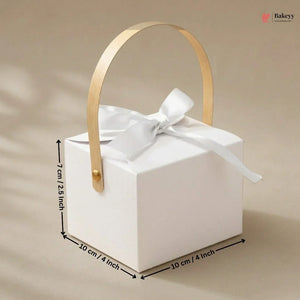 White gift box with gold handle and white ribbon, shown with measurements on a beige background.