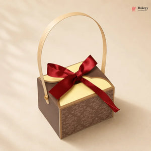 Gift box with a red ribbon on a beige background